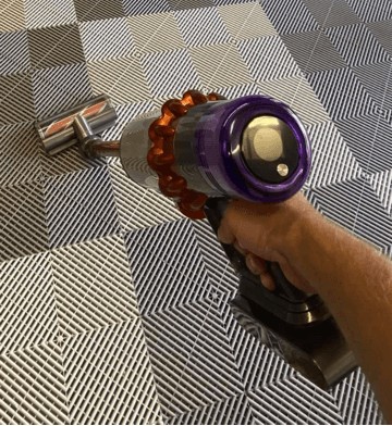 vacuuming a swisstrax flooring 