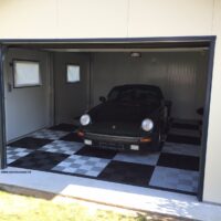 Porsche in a garage with wide checkerboard