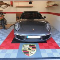 gray porsche in a garage with clip-on floor tiles SWISSTRAX