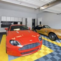 cars in a garage with yellow and gray modular flooring
