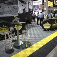welcoming area at an exhibition with floor tiles in grey, yellow and black