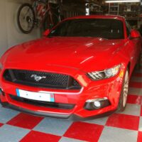 grey and red checkered pattern in a garage with a mustang