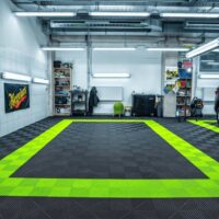 Jet Black and Techno Green Ribtrax Tiles in a professional car cleaning center